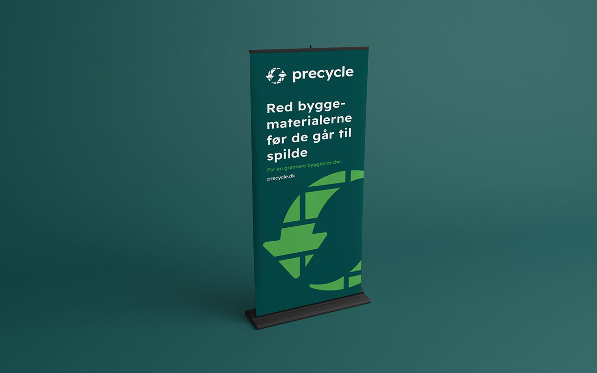 Visualisering af en mørkegrøn rollup for Precycle. Teksten er "Red byggematerialerne før de går til spilde. For en grønnere byggebranche. Precycle.dk"
